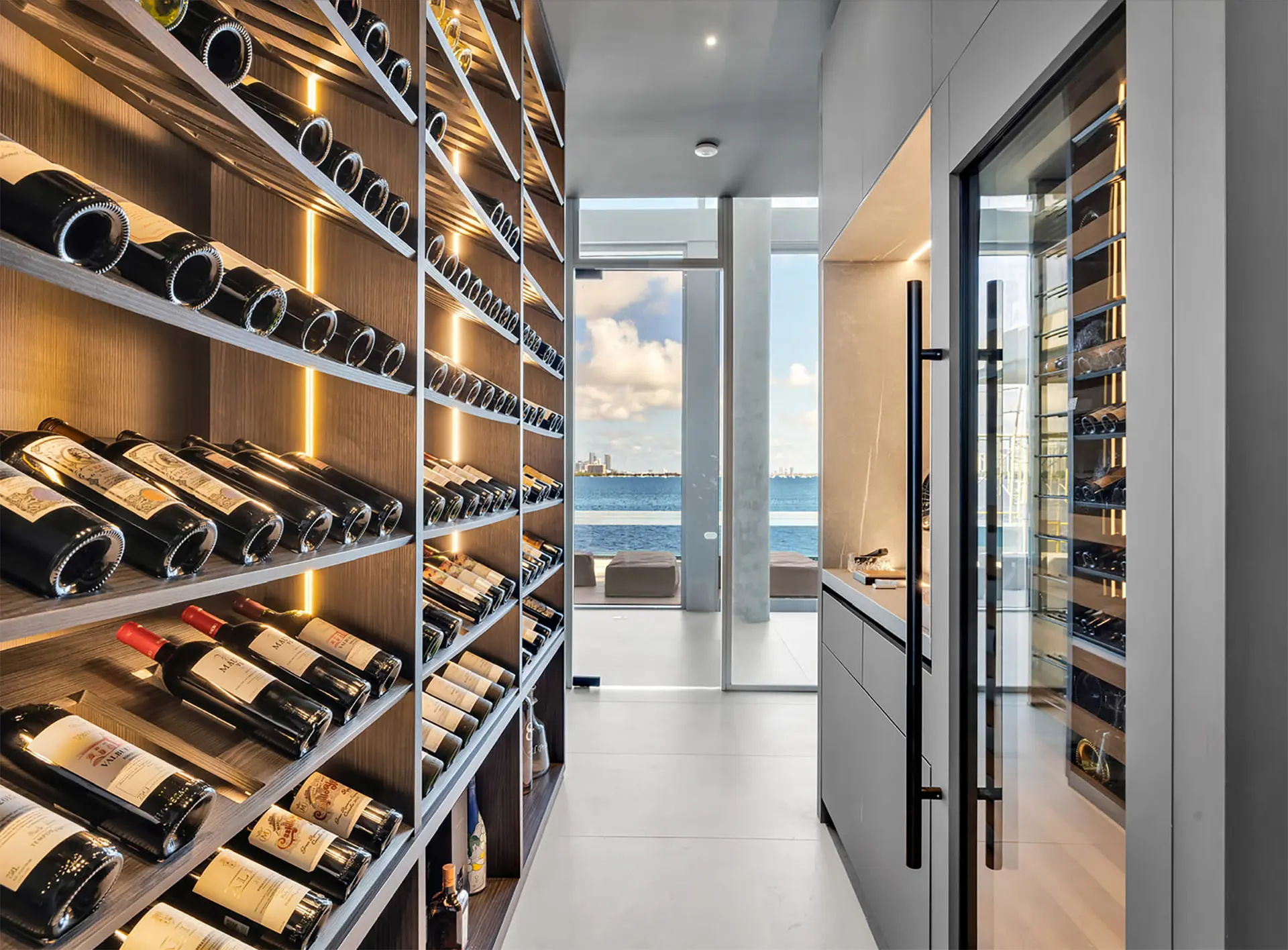 Luxury custom wine cellar with floor-to-ceiling wine racks overlooking Biscayne Bay, Miami — designed by CellArtus